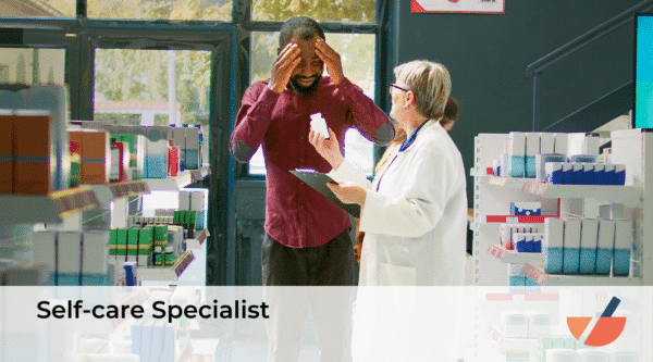 A pharmacist in a white coat assists a customer who appears to be in discomfort. The customer, a man in a red shirt, is holding his head in his hands while the pharmacist shows him a bottle of medication. They are in a pharmacy aisle filled with various products.